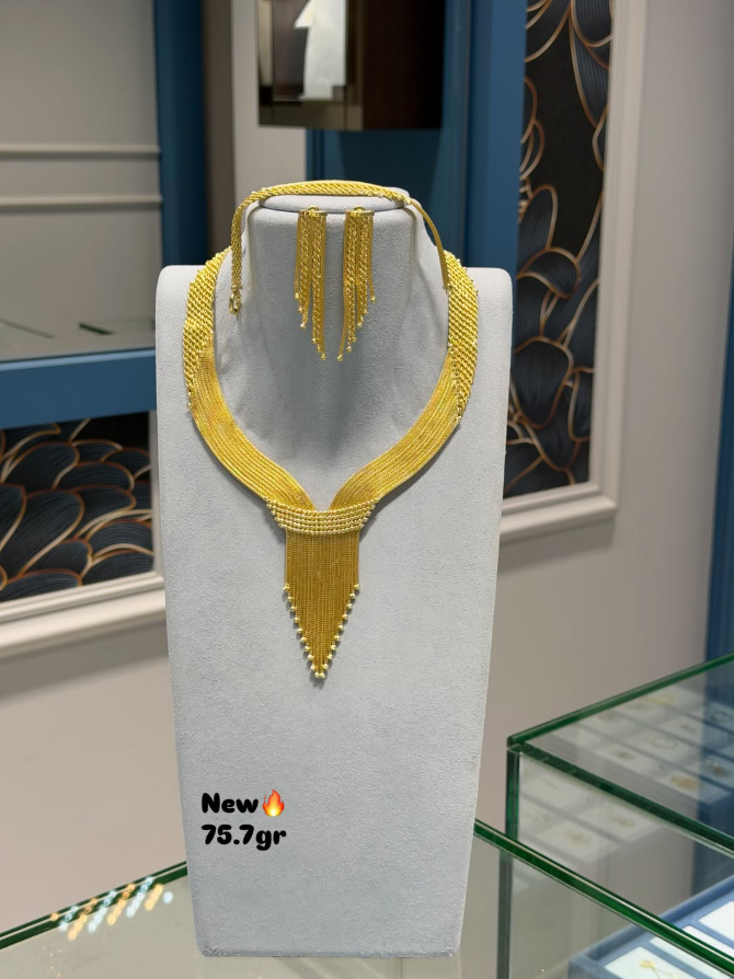A gold fringe necklace and matching earrings on a display bust in the Garnet Jewellery store